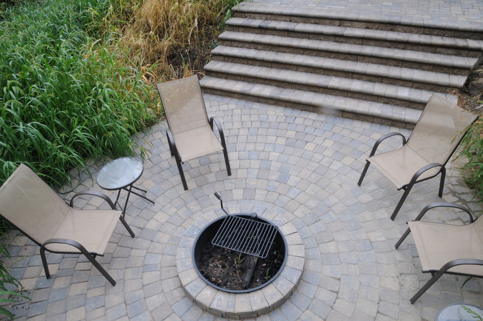 Small traditional backyard patio in Minneapolis with a fire feature, concrete pavers and no cover.
