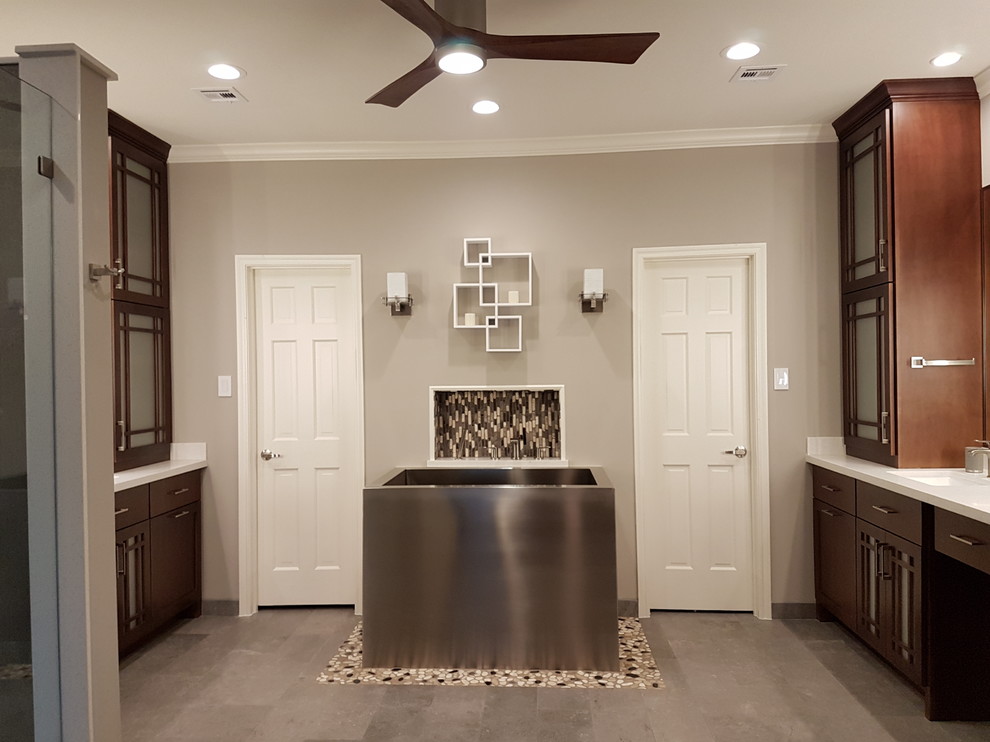 This is an example of a large asian master bathroom in Houston with shaker cabinets, medium wood cabinets, a japanese tub, a corner shower, a two-piece toilet, beige walls, ceramic floors, a drop-in sink, quartzite benchtops, grey floor and a hinged shower door.