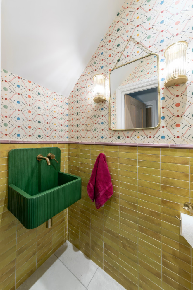 Small eclectic cloakroom in London with a wall-mounted sink and wallpapered walls.