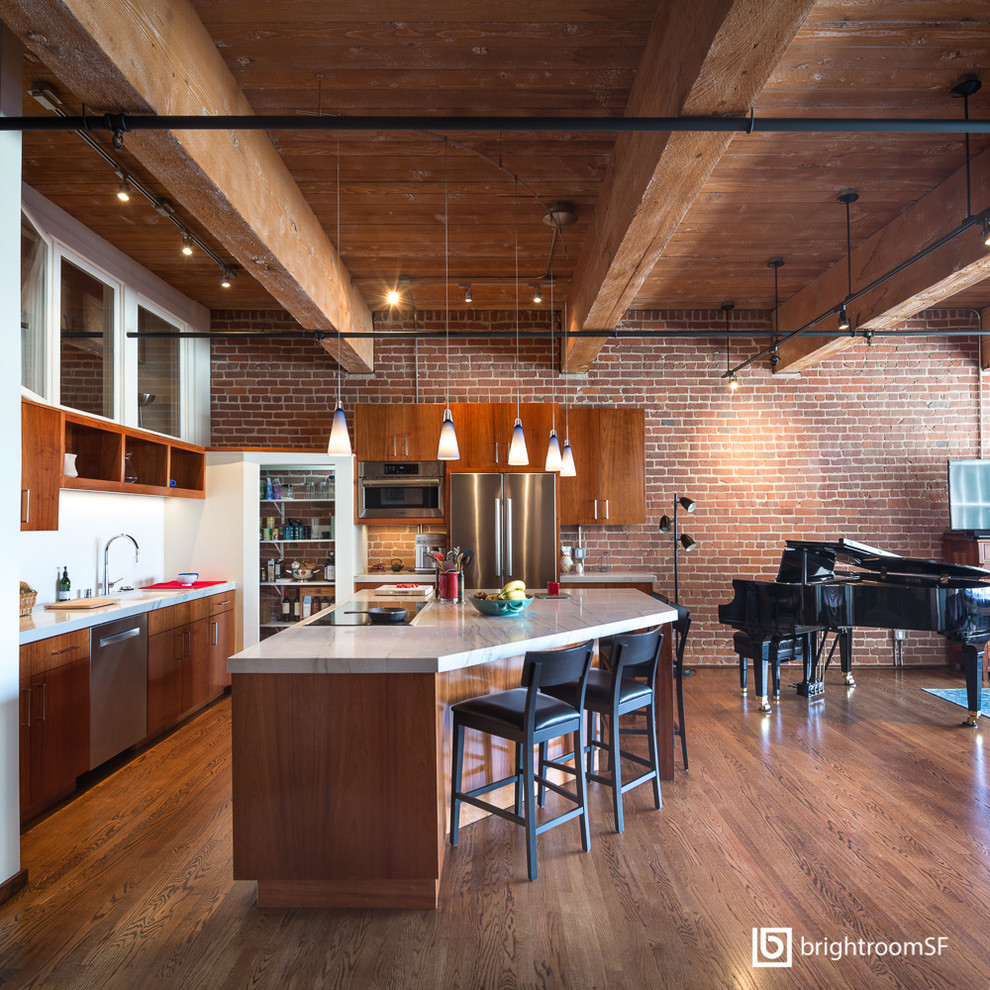 Inspiration for a mid-sized industrial l-shaped open plan kitchen in San Francisco with a single-bowl sink, dark hardwood floors and with island.