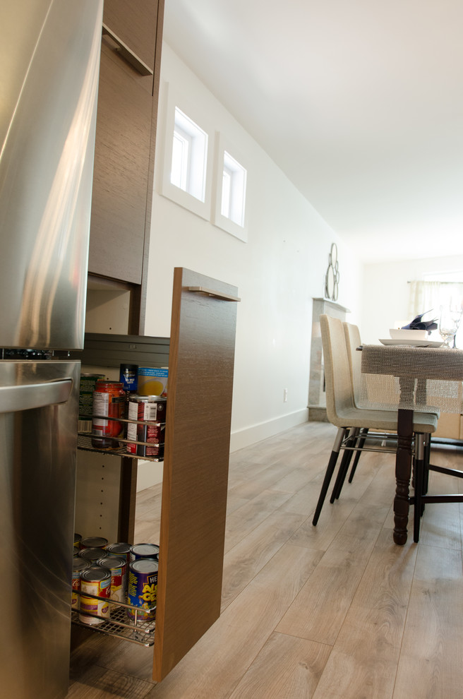 Inspiration for a mid-sized modern u-shaped dark wood floor eat-in kitchen remodel with a double-bowl sink, flat-panel cabinets, medium tone wood cabinets, quartzite countertops, white backsplash, mosaic tile backsplash, stainless steel appliances and an island