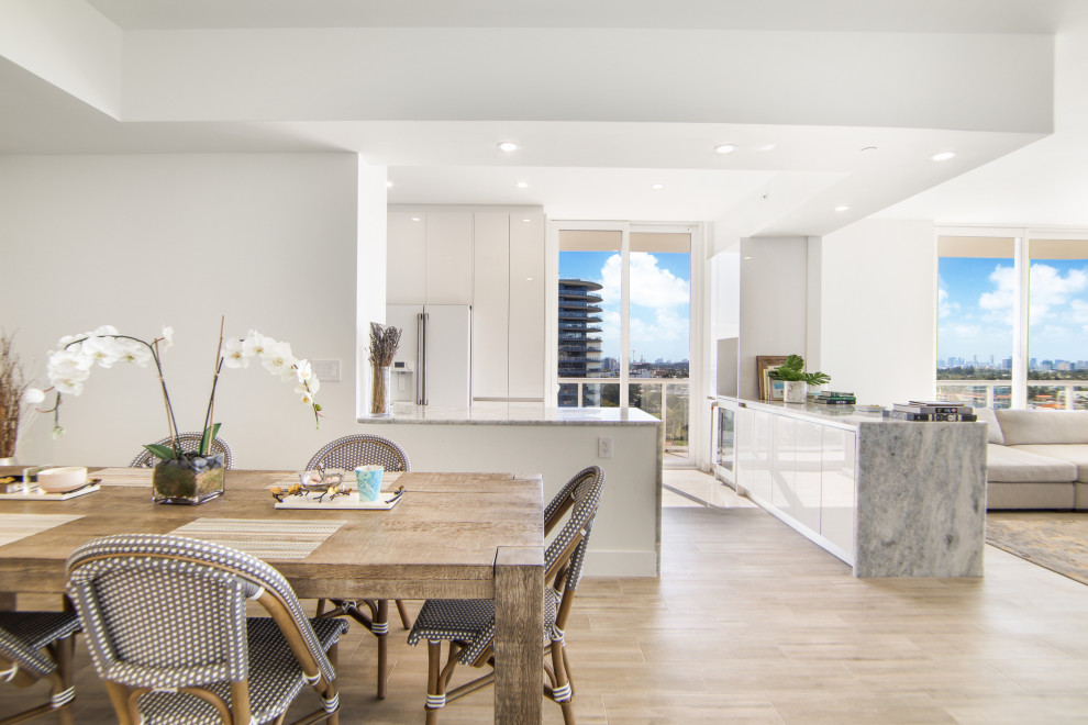 Example of a large transitional porcelain tile and brown floor great room design in Miami with white walls