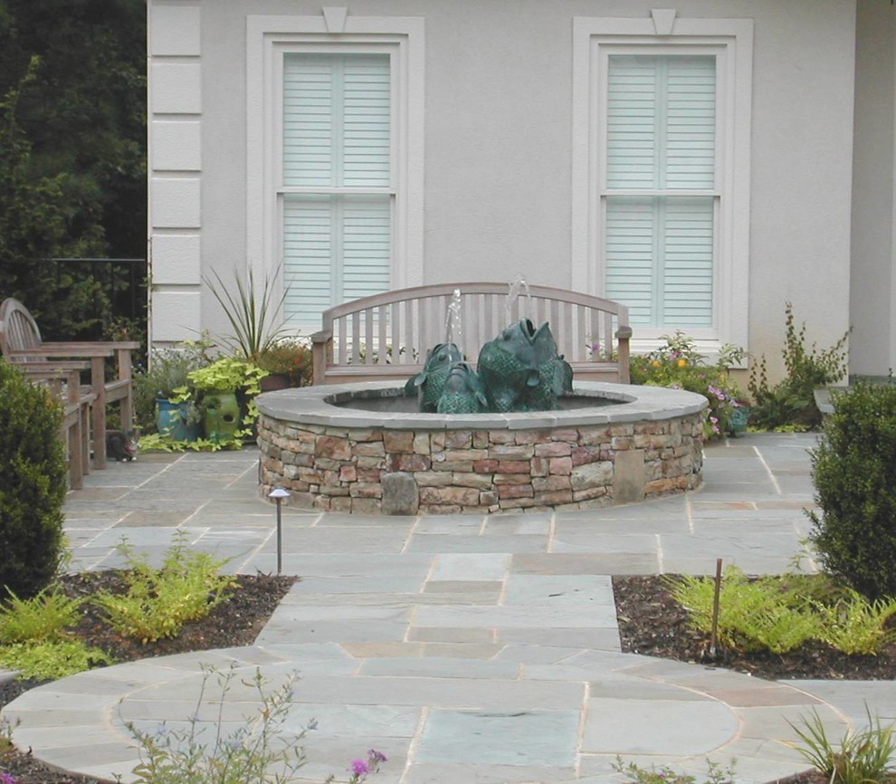 Design ideas for a mid-sized contemporary full sun backyard stone water fountain landscape.