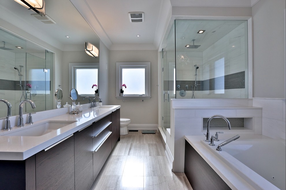 Contemporary master bathroom in Toronto with flat-panel cabinets, dark wood cabinets and a drop-in tub.