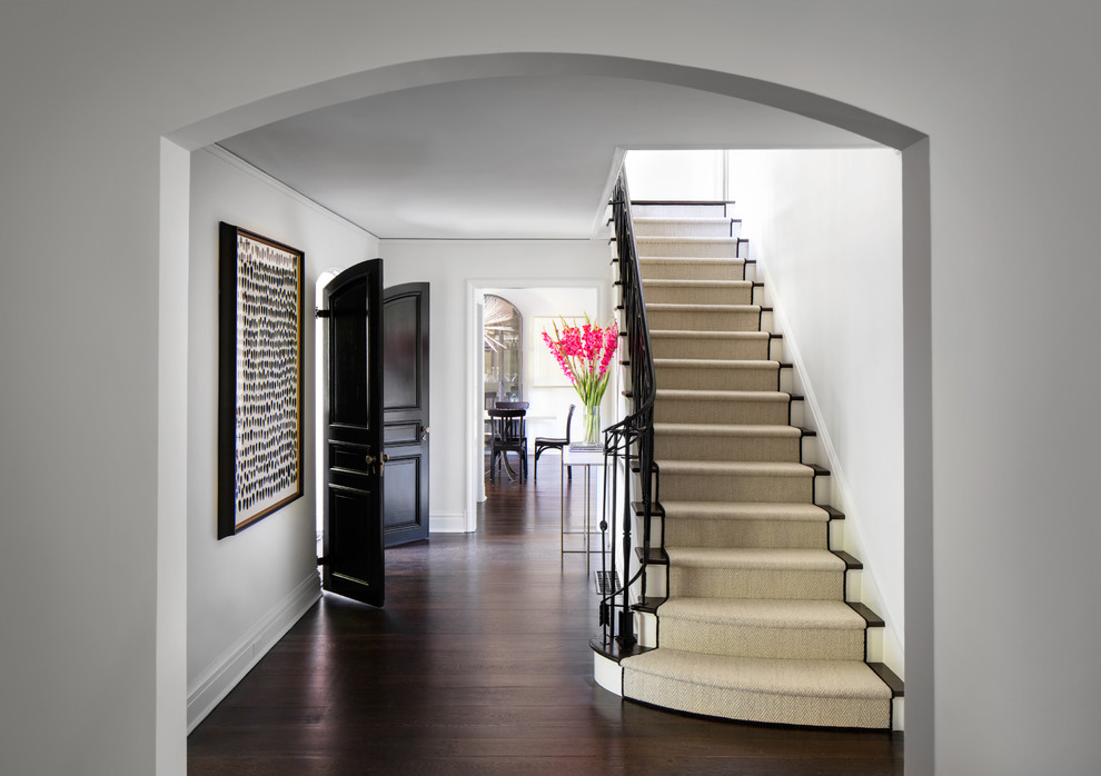 Inspiration for a transitional carpeted straight staircase in New York with carpet risers and metal railing.