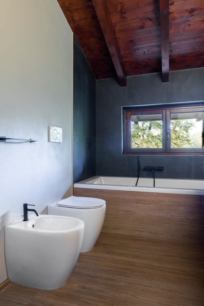 Aménagement d'une petite salle de bain principale montagne avec des portes de placard marrons, un bidet, un lavabo intégré, un sol marron, un plan de toilette blanc, meuble double vasque, meuble-lavabo suspendu et un plafond en bois.