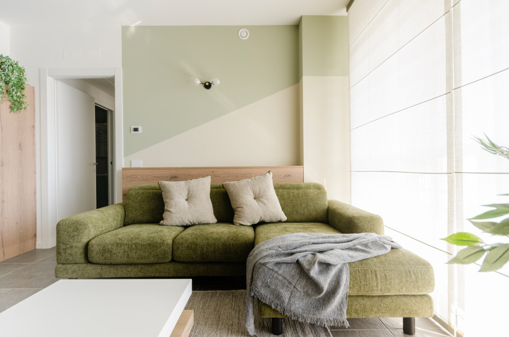 На фото: изолированная гостиная комната среднего размера в современном стиле с разноцветными стенами, полом из керамогранита, мультимедийным центром и коричневым полом без камина