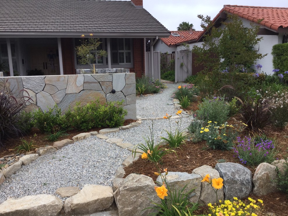Mid-sized asian front yard garden in San Diego with natural stone pavers.