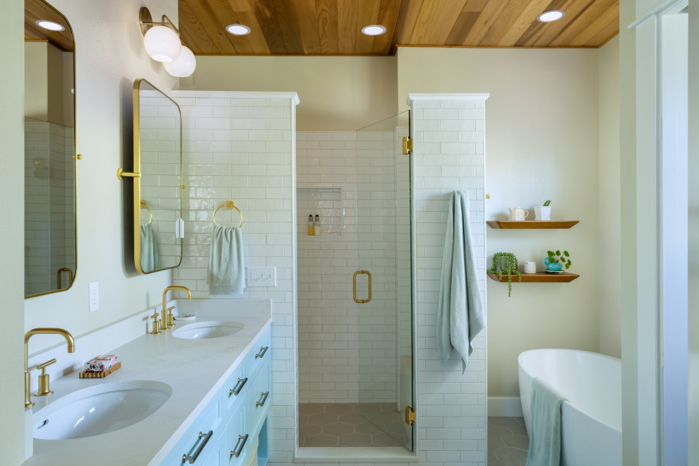 Inspiration for a mid-sized contemporary bathroom in Other with beaded inset cabinets, blue cabinets, a freestanding tub, a corner shower, a two-piece toilet, white tile, ceramic tile, beige walls, porcelain floors, an undermount sink, engineered quartz benchtops, beige floor, a hinged shower door, white benchtops, a shower seat, a double vanity, a built-in vanity and wood.