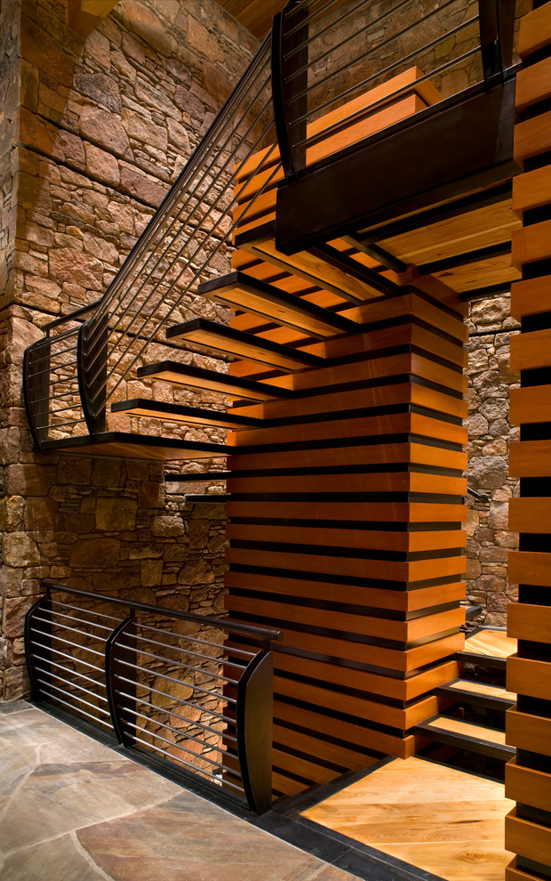 This is an example of a large contemporary wood u-shaped staircase in Denver with open risers.