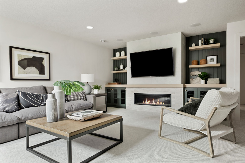 Scandinavian fully buried basement in Minneapolis with white walls, carpet, a standard fireplace and white floor.