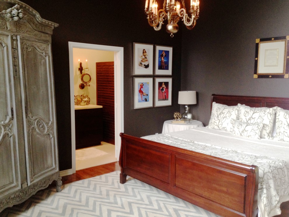 Inspiration for a transitional master bedroom in Houston with grey walls and medium hardwood floors.