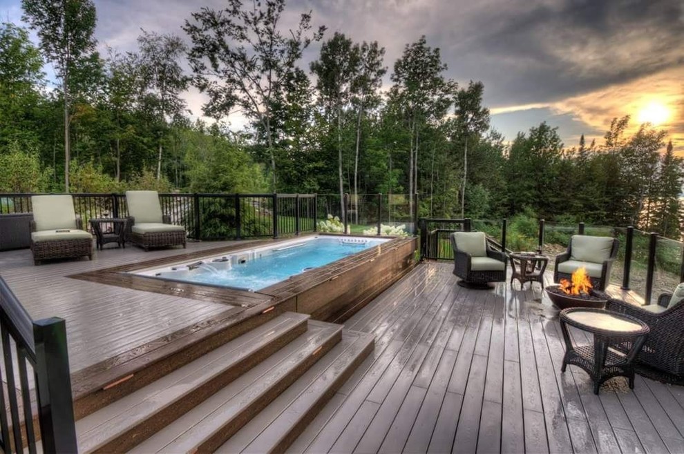 This is an example of a large country backyard deck in Toronto with a fire feature and no cover.