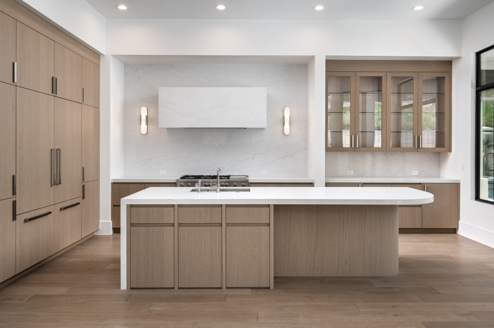 This is an example of a large modern l-shaped kitchen in Phoenix with medium hardwood floors, flat-panel cabinets, medium wood cabinets, quartz benchtops and engineered quartz splashback.