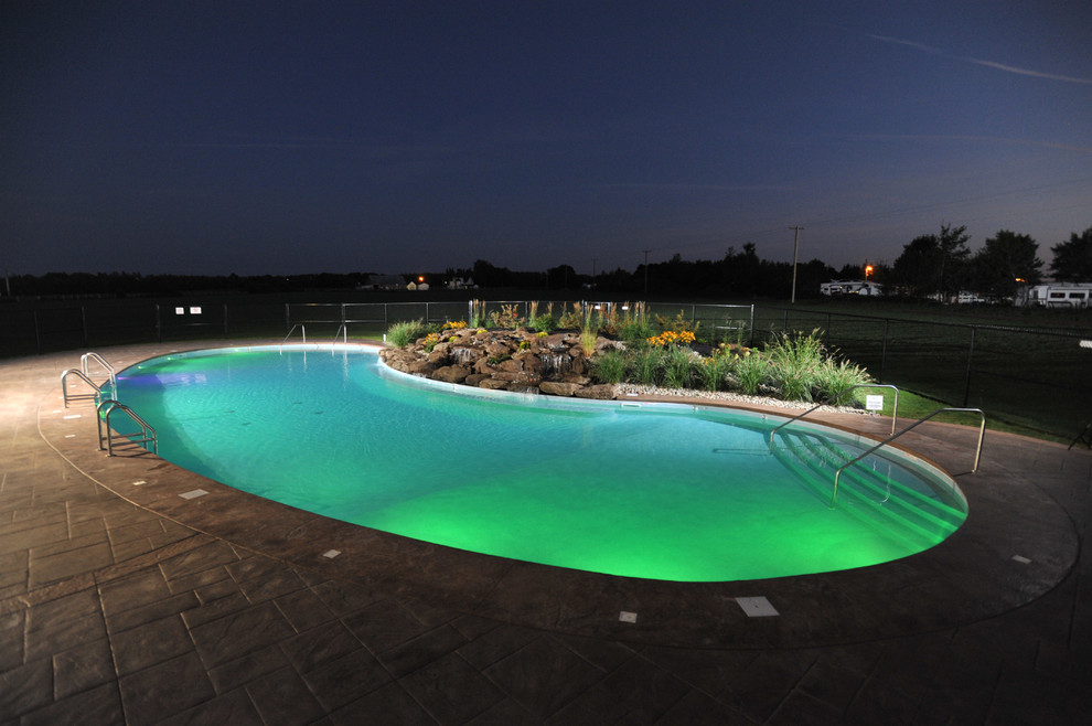 Inspiration for a huge rustic courtyard stamped concrete and freeform natural pool fountain remodel