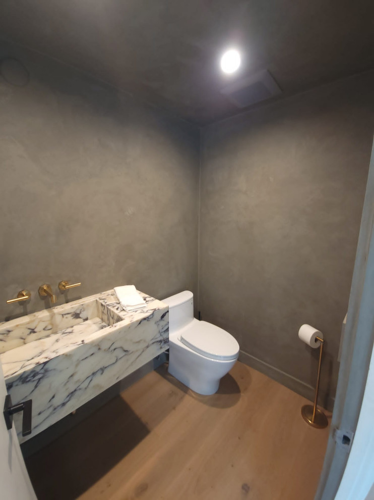 Inspiration for a cloakroom in Los Angeles with grey tiles, painted wood flooring, a wall-mounted sink and beige floors.