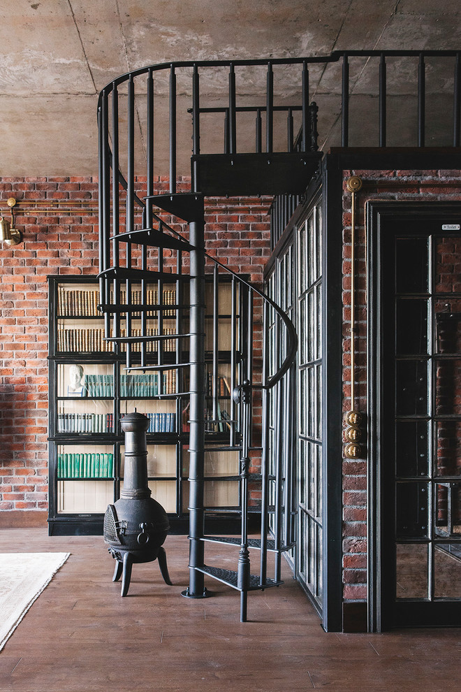 Industrial metal spiral staircase in Moscow with open risers and metal railing.