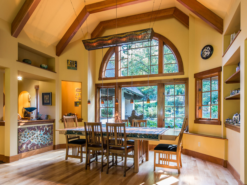 Photo of a mid-sized arts and crafts open plan dining in Seattle with beige walls, light hardwood floors and no fireplace.