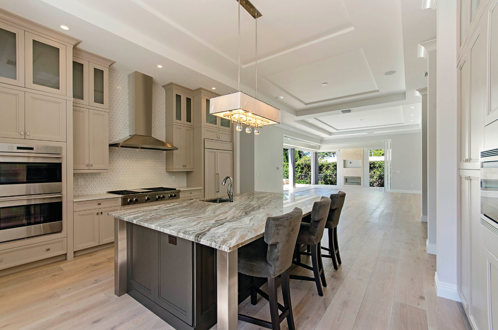 Transitional eat-in kitchen photo in Miami with a single-bowl sink, recessed-panel cabinets, beige cabinets, stainless steel appliances and an island