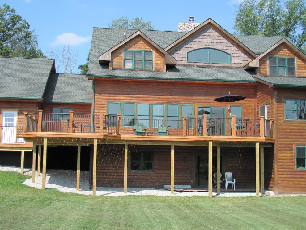 Example of a large mountain style backyard balcony deck design in Detroit with no cover