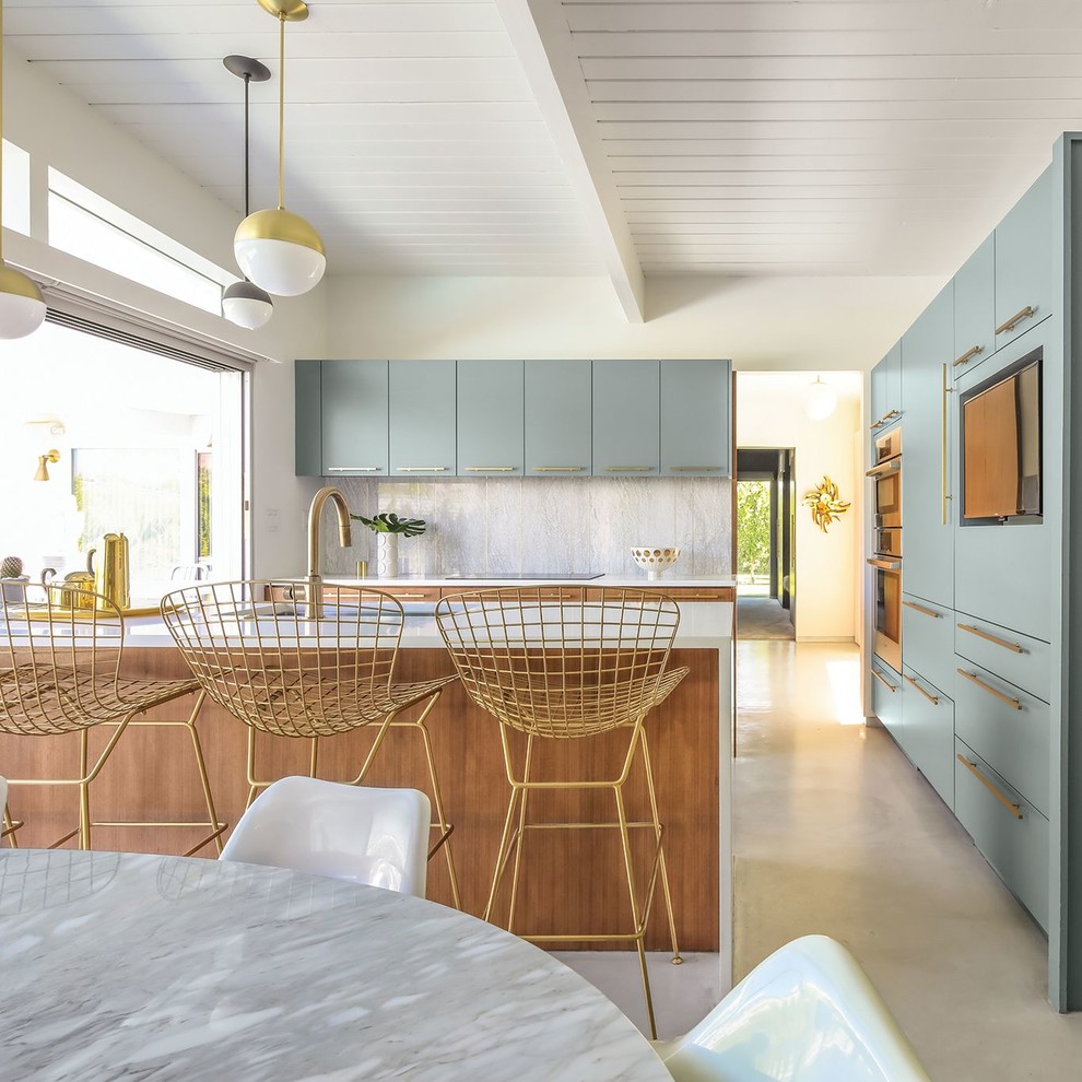 This is an example of a midcentury kitchen with quartz benchtops and beige benchtop.