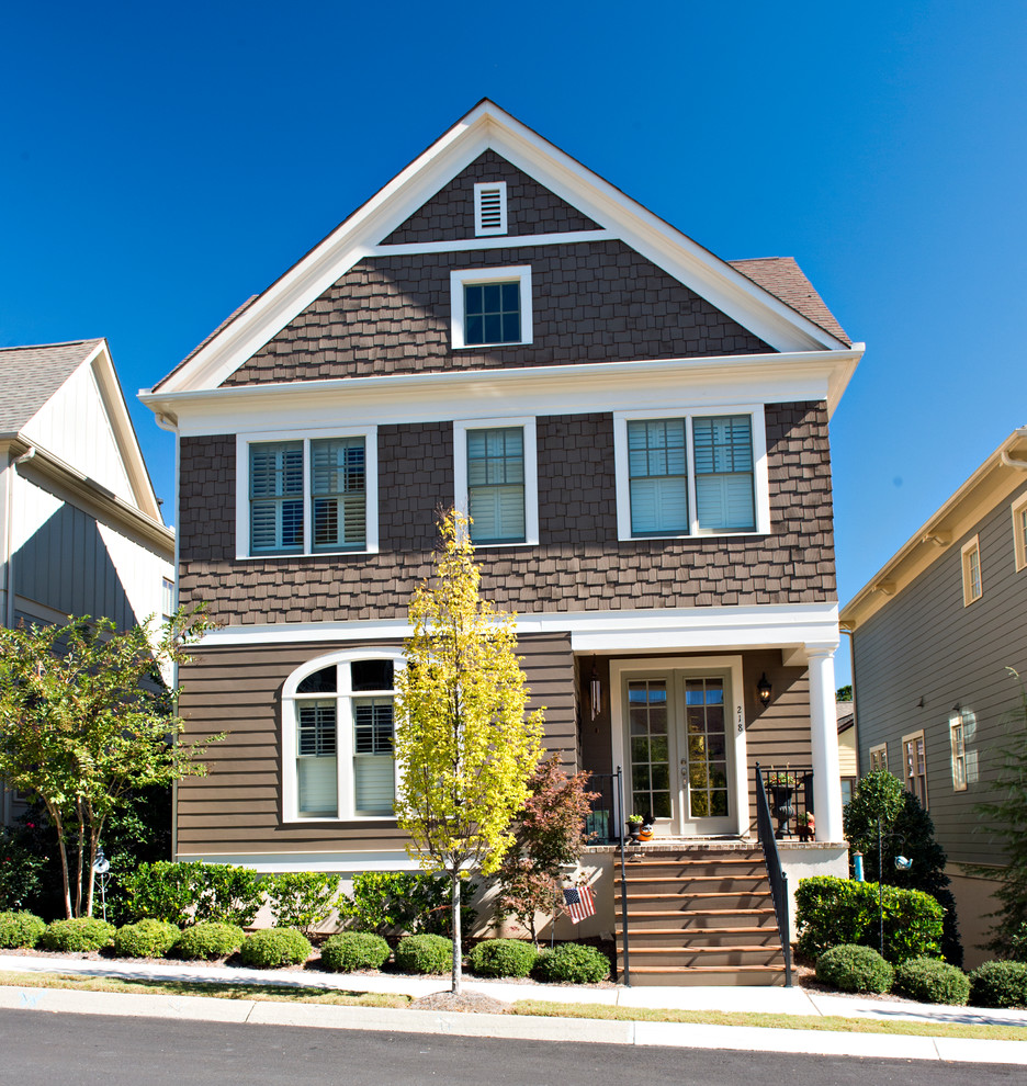 Photo of a large traditional three-storey brown exterior in Atlanta with mixed siding and a gable roof.