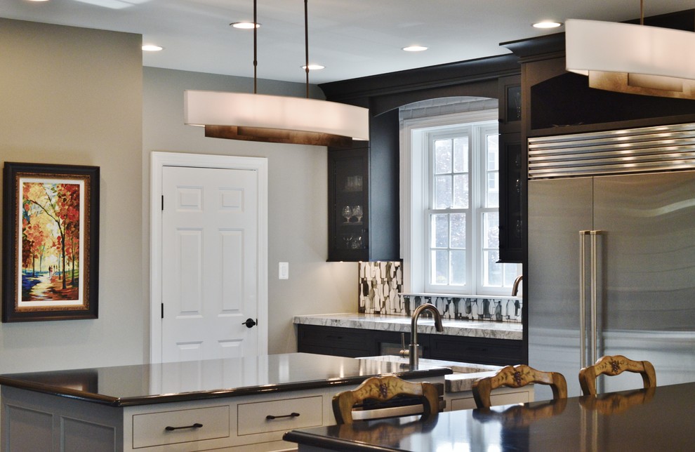 Enclosed kitchen - large transitional l-shaped dark wood floor enclosed kitchen idea in DC Metro with an undermount sink, dark wood cabinets, white backsplash, subway tile backsplash, stainless steel appliances, two islands and shaker cabinets
