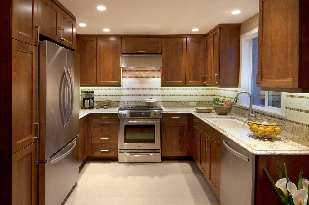 Example of a small transitional u-shaped porcelain tile enclosed kitchen design in Seattle with an undermount sink, recessed-panel cabinets, dark wood cabinets, quartz countertops, beige backsplash, cement tile backsplash, stainless steel appliances and no island
