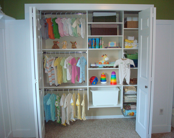 This is an example of a mid-sized contemporary gender-neutral built-in wardrobe in Charlotte with open cabinets, white cabinets, carpet and beige floor.
