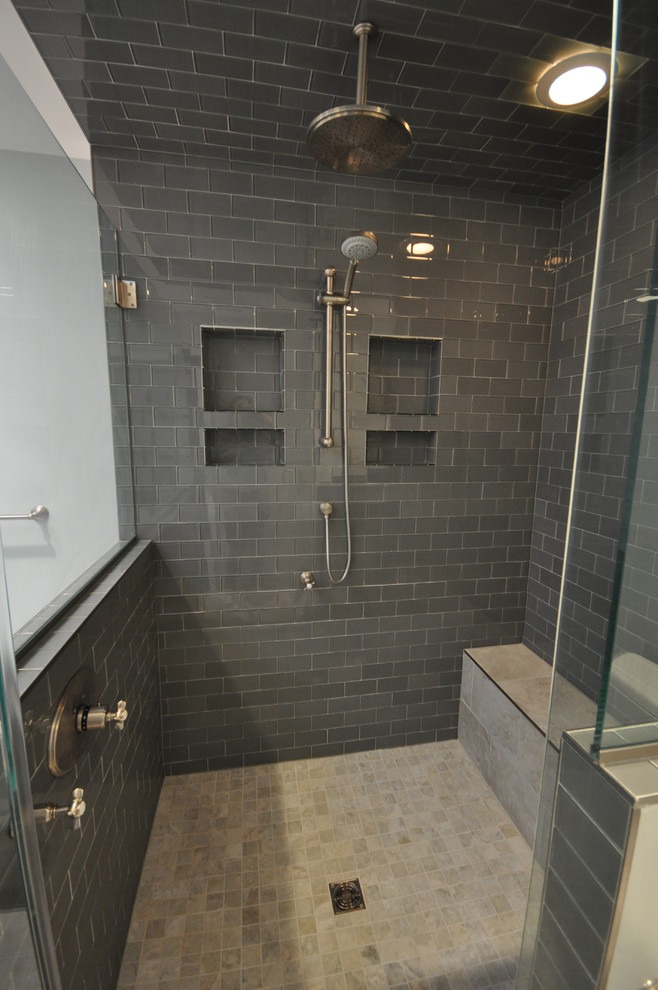 This is an example of a mid-sized transitional master bathroom in DC Metro with shaker cabinets, black cabinets, a double shower, a one-piece toilet, black tile, subway tile, blue walls, a wall-mount sink, beige floor and a hinged shower door.