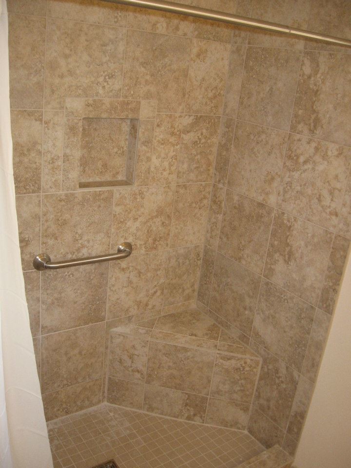 Ceramic tile corner shower photo with beige walls