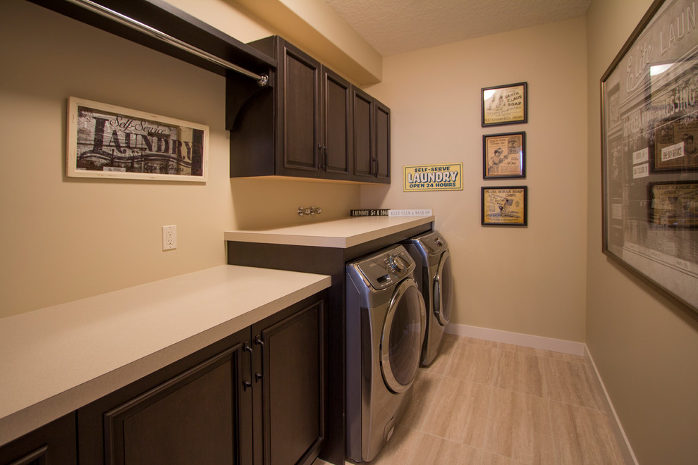 This is an example of a transitional single-wall laundry room in Calgary with recessed-panel cabinets, dark wood cabinets, laminate benchtops, brown walls, ceramic floors and a side-by-side washer and dryer.