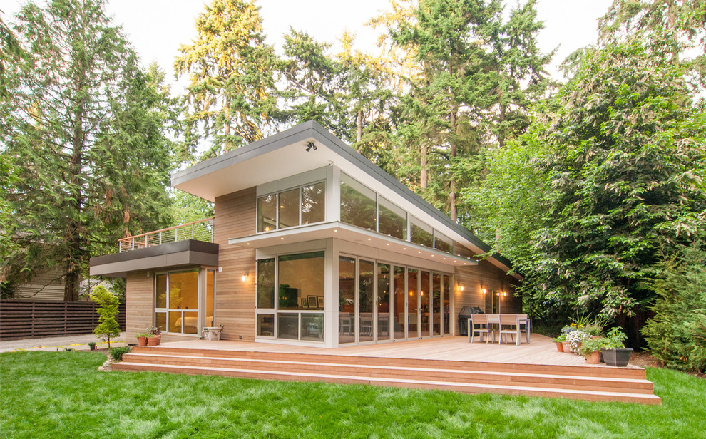 Photo of a contemporary exterior in Seattle with wood siding and a shed roof.
