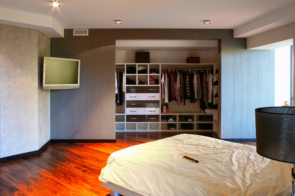 Inspiration for a mid-sized contemporary gender-neutral built-in wardrobe in Other with open cabinets, white cabinets, medium hardwood floors and red floor.