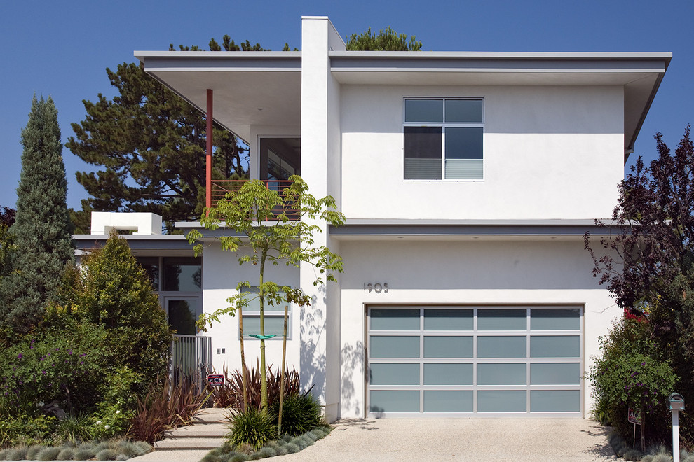 Design ideas for a large modern two-storey stucco white exterior in Los Angeles with a flat roof.