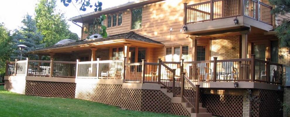 Deck - large transitional backyard deck idea in Denver with a roof extension