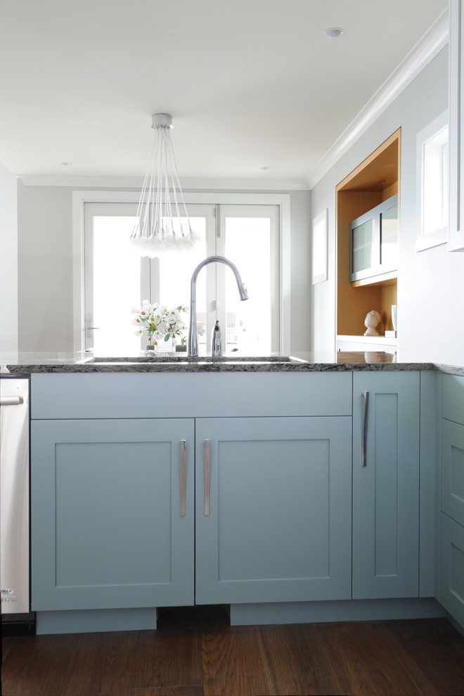 Open concept kitchen - large transitional u-shaped medium tone wood floor open concept kitchen idea in Vancouver with an undermount sink, shaker cabinets, blue cabinets, quartz countertops, metallic backsplash, glass tile backsplash and stainless steel appliances