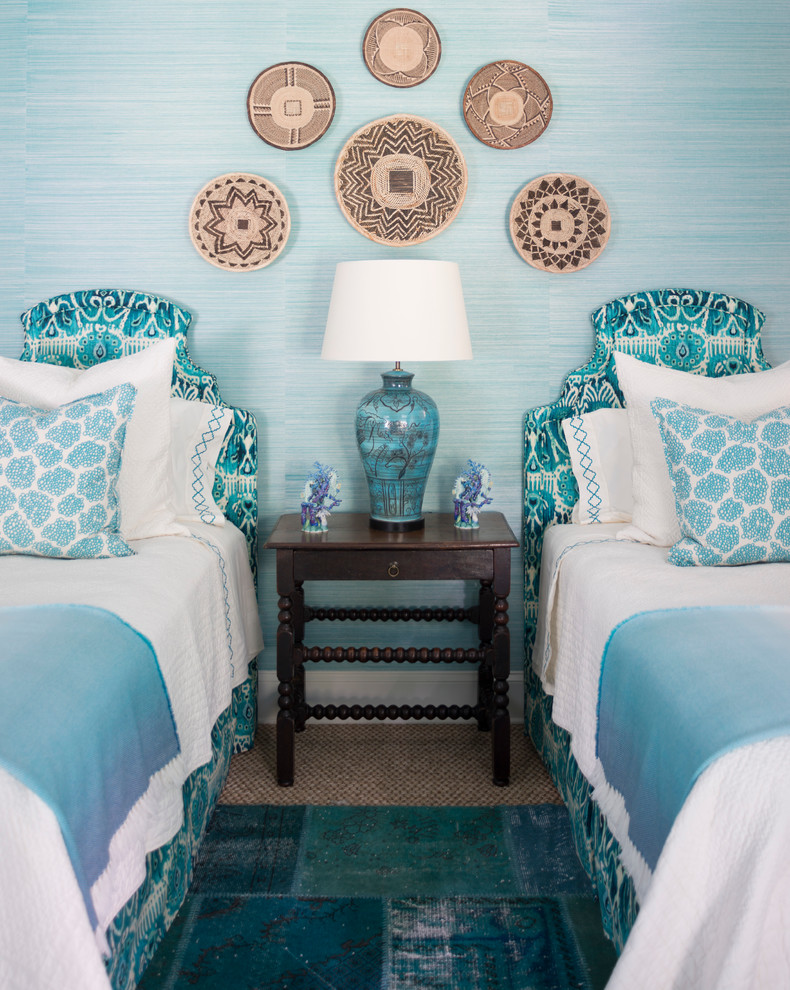 This is an example of a large tropical guest bedroom in Atlanta with blue walls and carpet.