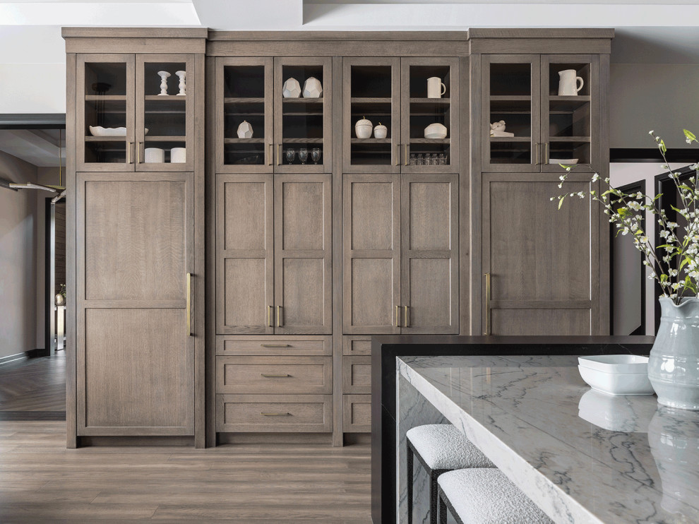 Inspiration for a transitional eat-in kitchen in Detroit with an undermount sink, shaker cabinets, medium wood cabinets, quartzite benchtops, grey splashback, engineered quartz splashback, panelled appliances, with island, brown floor, grey benchtop and recessed.