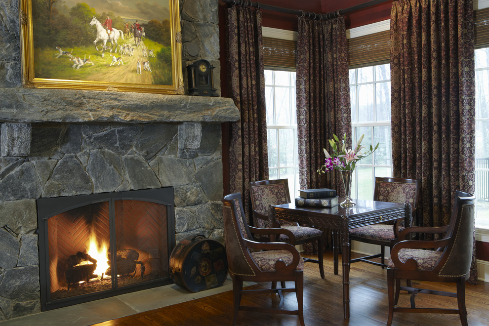 Inspiration for a large traditional enclosed family room in New York with red walls, medium hardwood floors, a standard fireplace and a stone fireplace surround.