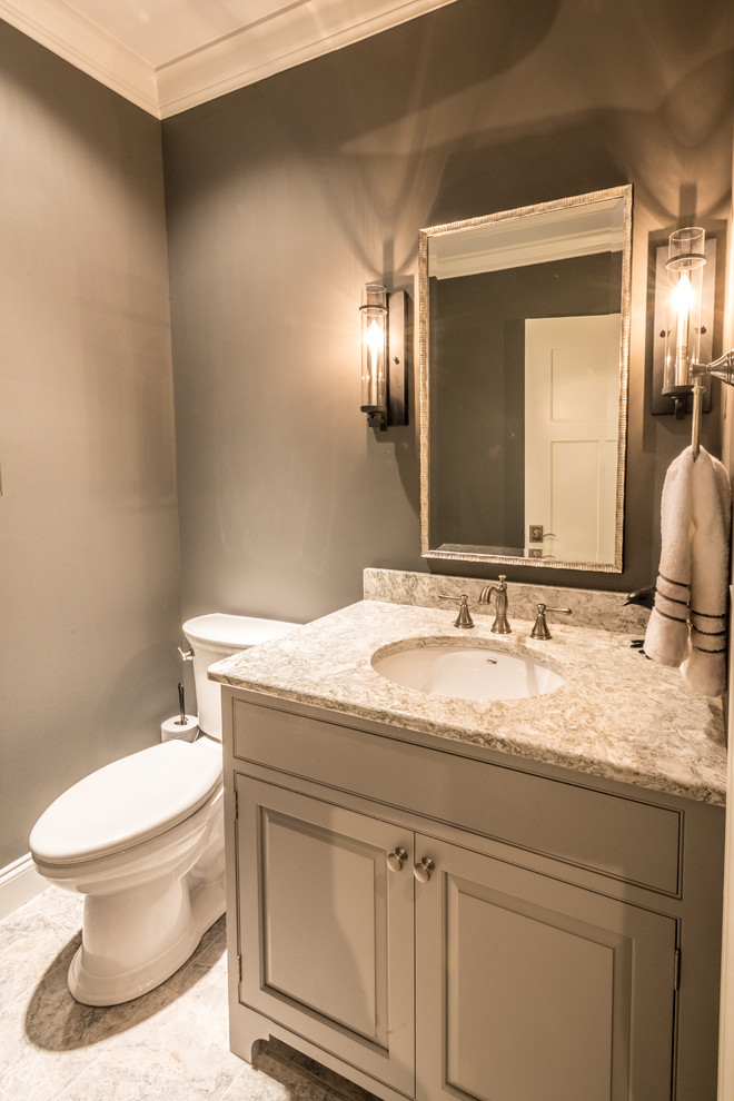 Design ideas for a mid-sized transitional powder room in Other with beaded inset cabinets, grey cabinets, a one-piece toilet, gray tile, ceramic tile, grey walls, ceramic floors, a drop-in sink and granite benchtops.
