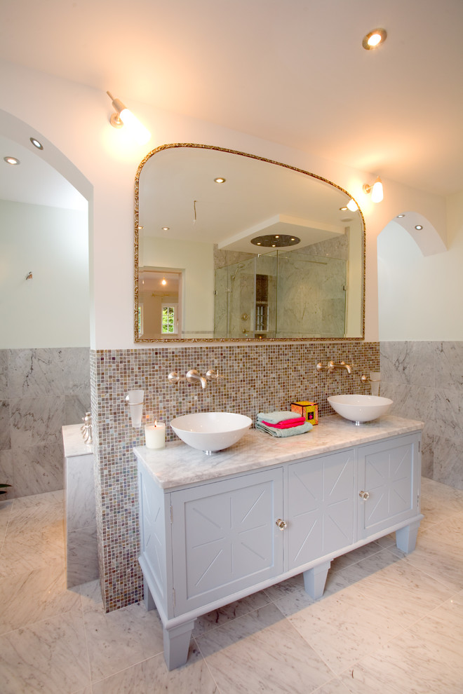 Inspiration for a transitional master bathroom in Sussex with a vessel sink, recessed-panel cabinets, grey cabinets, mosaic tile, white walls, marble benchtops, marble floors and brown tile.