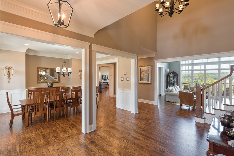 Mid-sized transitional dark wood floor and brown floor enclosed dining room photo with beige walls