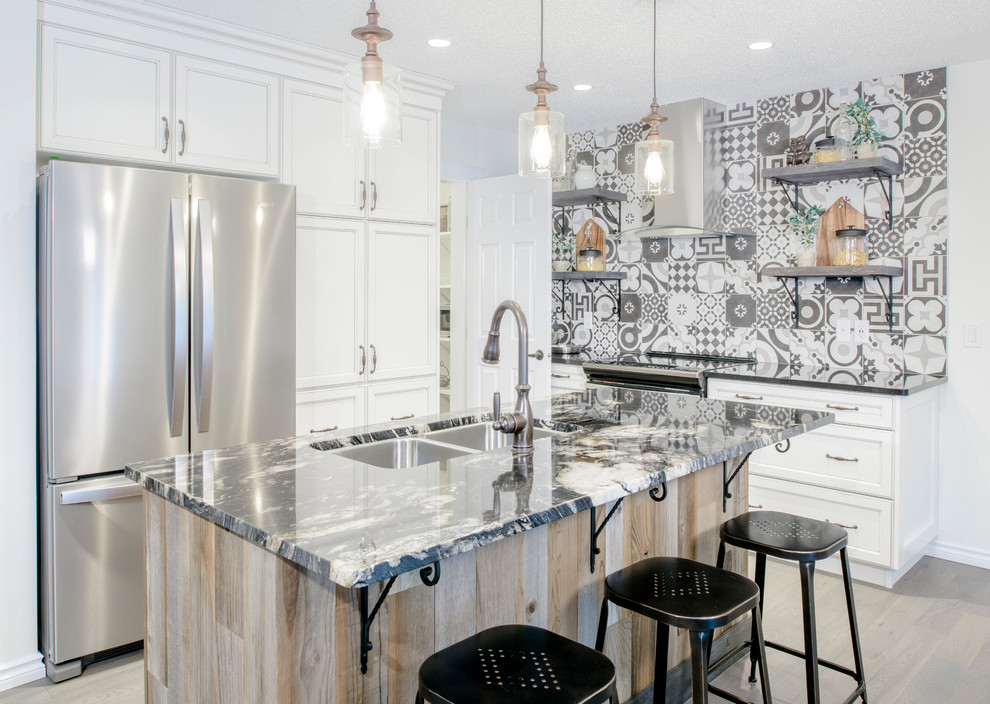Example of a transitional light wood floor enclosed kitchen design in Edmonton with a double-bowl sink, recessed-panel cabinets, white cabinets, multicolored backsplash, stainless steel appliances, an island and multicolored countertops