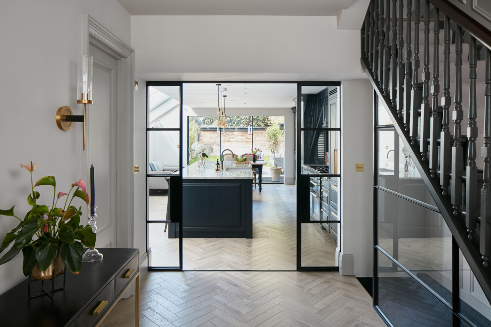 Inspiration for a large traditional kitchen in London with flat-panel cabinets, black cabinets and with island.