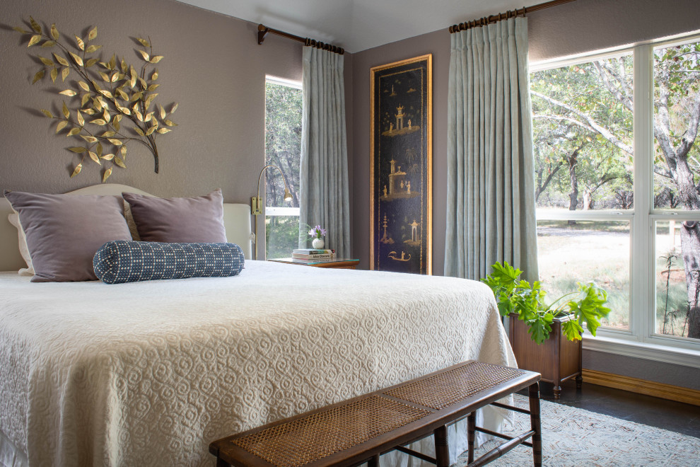 Transitional master bedroom in Austin with purple walls, concrete floors and brown floor.