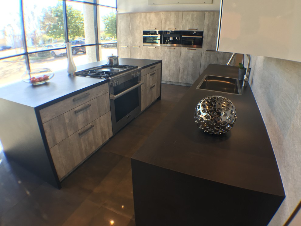 Photo of a large modern eat-in kitchen in Orange County with louvered cabinets, white cabinets, grey splashback, porcelain splashback and with island.