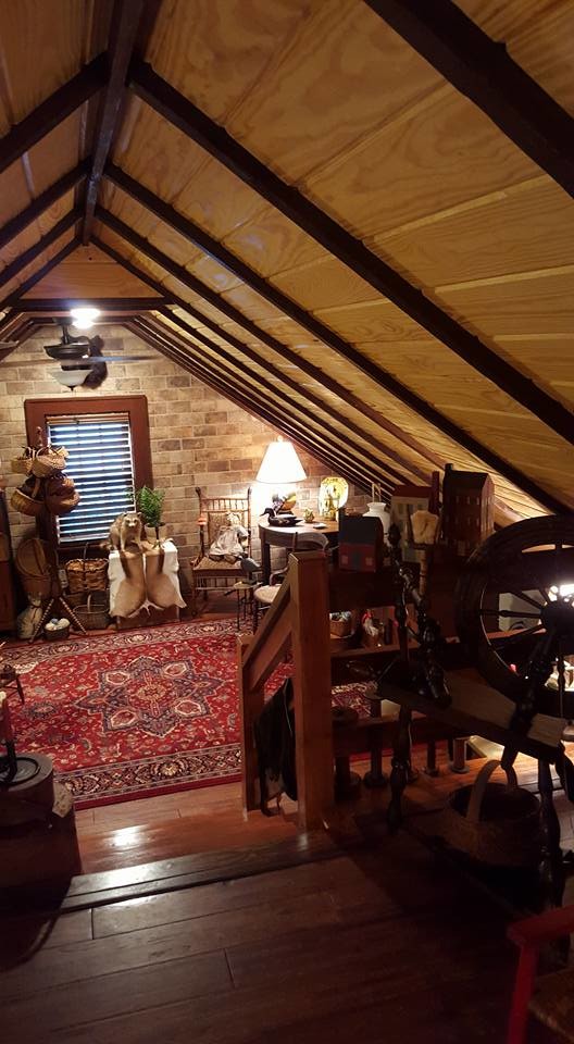 Bedroom - large rustic loft-style medium tone wood floor bedroom idea in Atlanta with brown walls