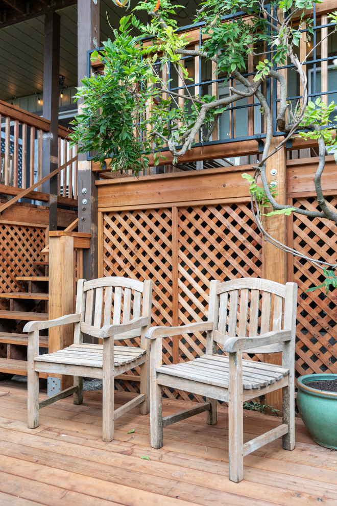 Large mountain style backyard ground level wood railing deck photo in San Francisco with no cover