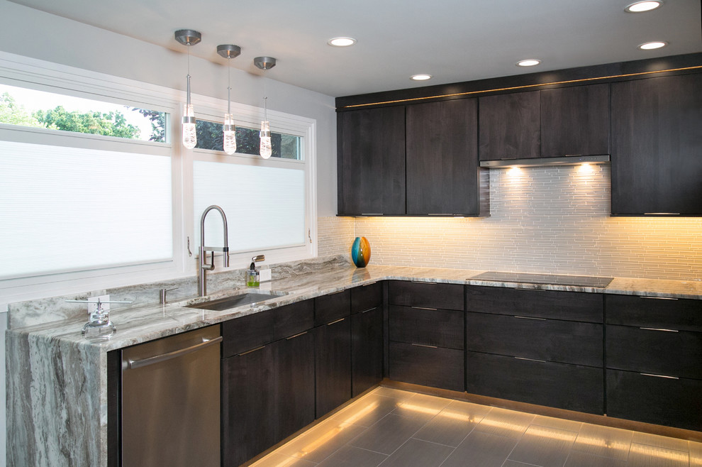 Photo of a small modern u-shaped separate kitchen in Philadelphia with an undermount sink, flat-panel cabinets, dark wood cabinets, quartzite benchtops, white splashback, glass tile splashback, stainless steel appliances, porcelain floors, no island and brown floor.